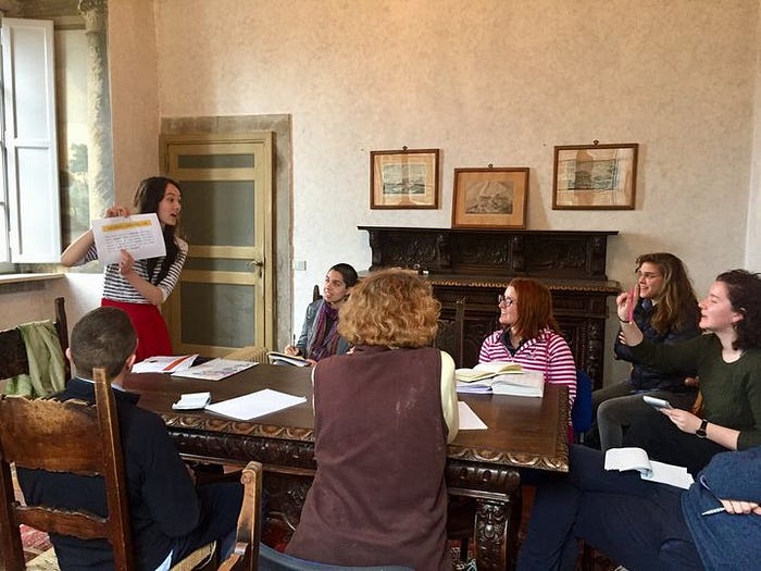  An early Oxford Latinitas Society class, being taught by Jenny Rallens. (Photo from oxfordlatinitas.org)