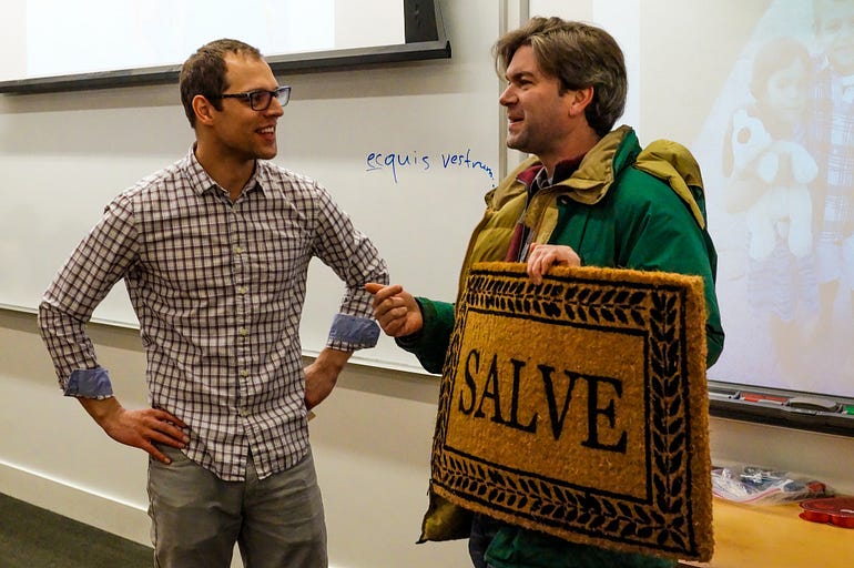  John Byron Kuhner saying “Salve” with a doormat.
