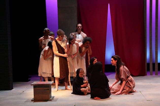  Amphitryon (Cat Lambert) and the chorus visit the wife (Elizabeth McNamara) and children of Herakles. (Photo: Pamela Sisson)

