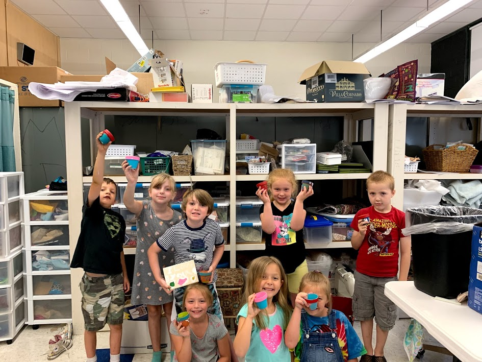  Students holding paper pots they designed at an Aequora Summer Camp in Salisbury, MA.
